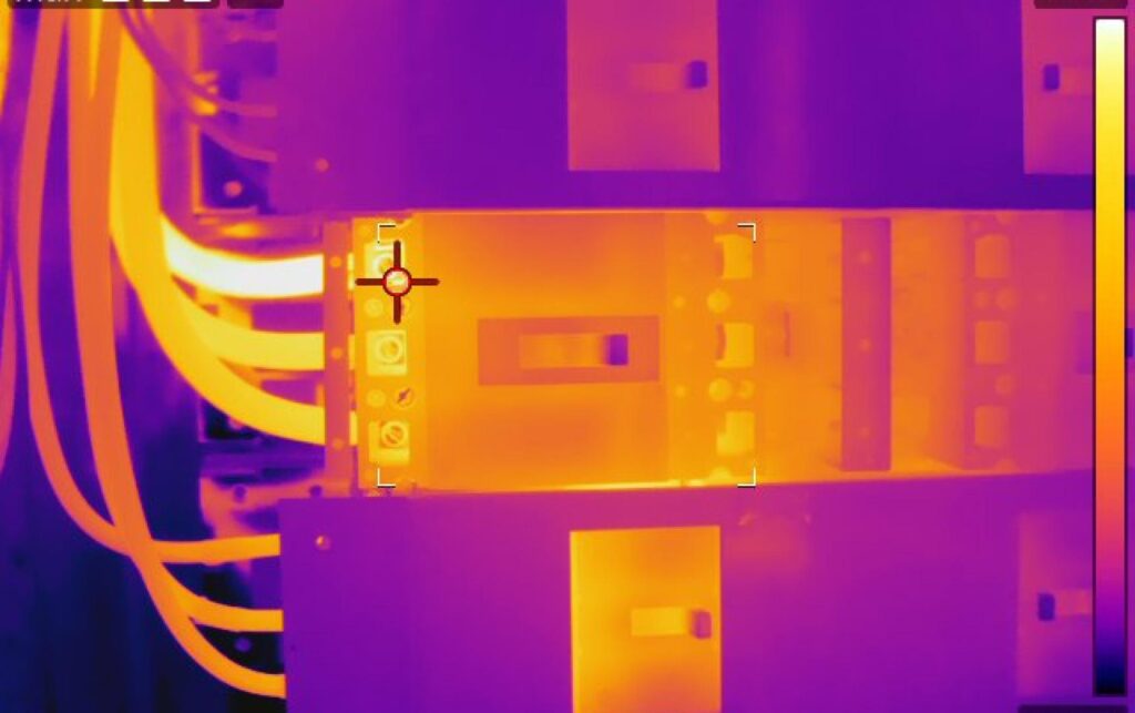 Thermal imaging traditional inspections revealing hotspot in electrical switchboard