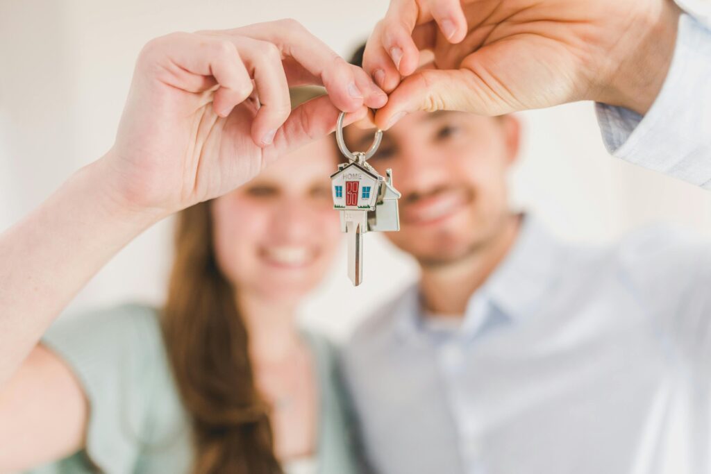 Happy family holding new home keys after safety check with thermal imaging traditional inspections
